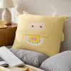 A cute beige cartoon plush pillow with ears and a pink face, featuring candy patterns, is a warm and cozy gift details Picture